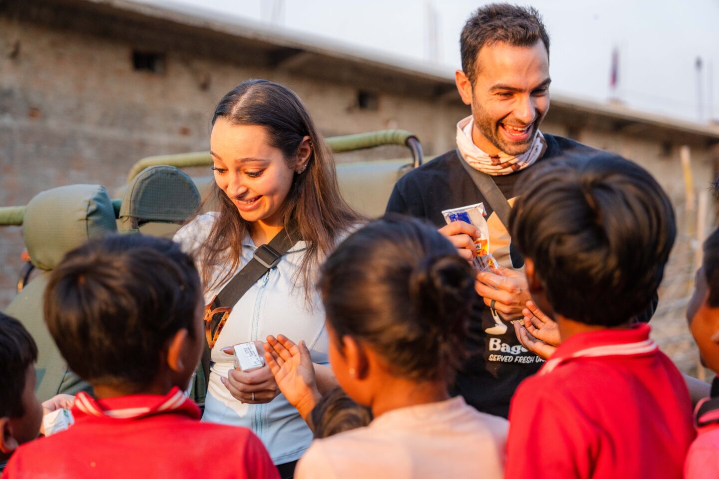 Guests with community children during a Signature safari with Suyash